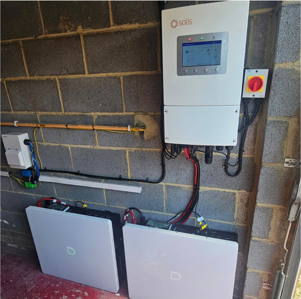 Solis hybrid inverter paired with two wall-mounted home battery storage units in a garage